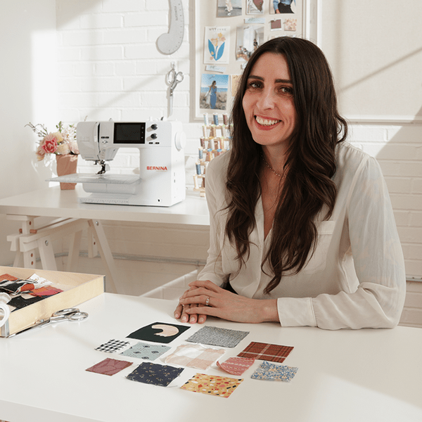 Image lady sitting at desk with fabric swatches